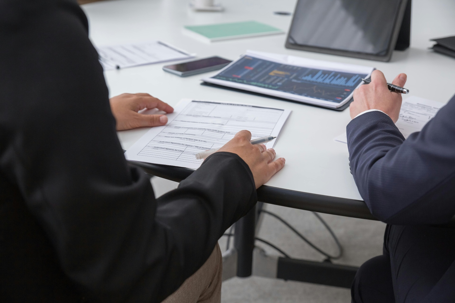 Bookkeeper reviewing financial records with a small business owner
